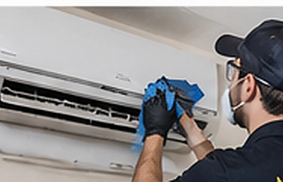 Illustrative technician cleaning wall-mounted split-system air conditioner